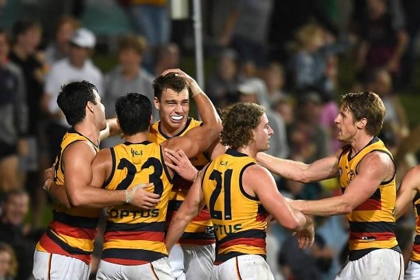 Riley Thilthorpe of the Crows celebrates with team mates after kicking the match winning goal during the round 13 AFL match between the St Kilda...