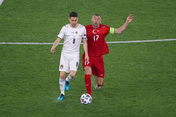 Jorginho of Italy, Burak Yilmaz of Turkey during the UEFA Euro 2020 Group A match between Turkey and Italy at Stadio Olympico on June 11, 2021 in...