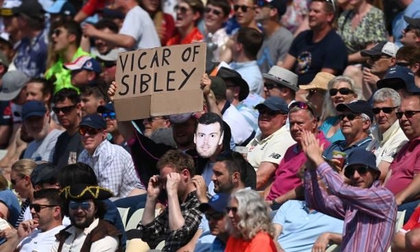 Sign saying 'The Vicar of Sibley' is pictured in the Hollies Stand alongside masks of the England opening batsman during day three of the second LV=...