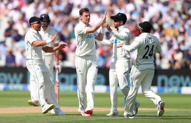 New Zealand bowler Matt Henry celebrates with team mates after taking the wicket of England opening batsman Rory Burns for 0 during day three of the...