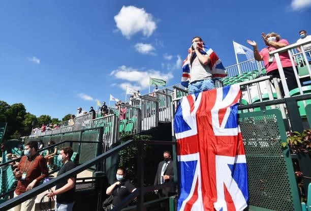 Man with a Great Britain flag cheers on Johanna Konta of Great Britain after she beats Nina Stojanovic of Serbia during theViking Open women's...