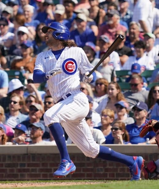 Jake Marisnick of the Chicago Cubs hits a single during the seventh inning of a game against the St. Louis Cardinals at Wrigley Field on June 11,...