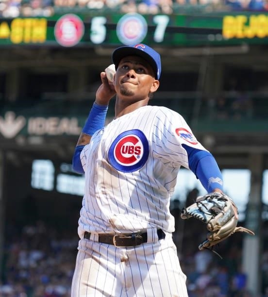 Sergio Alcántara of the Chicago Cubs throws a ball into the stands during the eighth inning of a game against the St. Louis Cardinals at Wrigley...