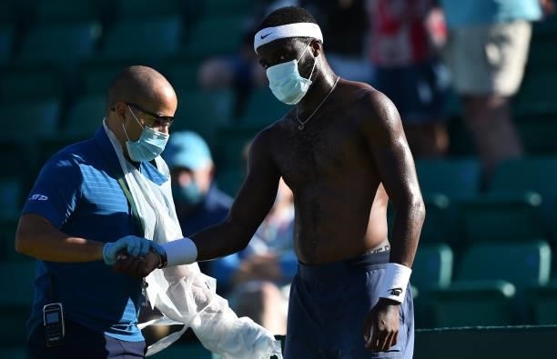 Frances Tiafore of United States receives treatment for an injury as he plays against Marius Copil of Romania during the men's semi-finals match on...