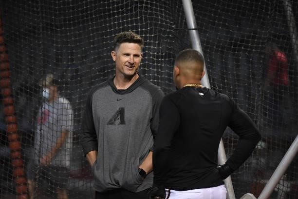 Co-Hitting coach Rick Short of the Arizona Diamondbacks talks with Eduardo Escobar during batting practice prior to a game against the Los Angeles...
