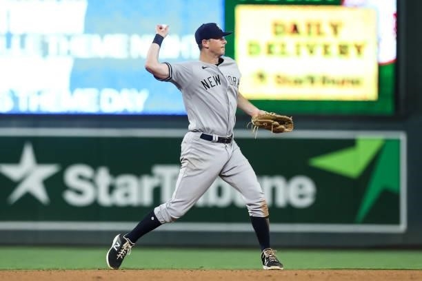 LeMahieu of the New York Yankees throws the ball to first base to get out Josh Donaldson of the Minnesota Twins in the seventh inning of the game at...