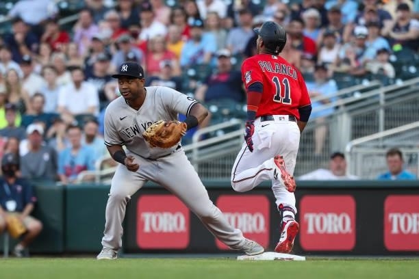 Chris Gittens of the New York Yankees fields a ball at first base for a force out against Jorge Polanco of the Minnesota Twins in the first inning of...