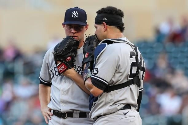 Michael King, left, talks to Gary Sanchez of the New York Yankees in the first inning of the game against the Minnesota Twins at Target Field on June...
