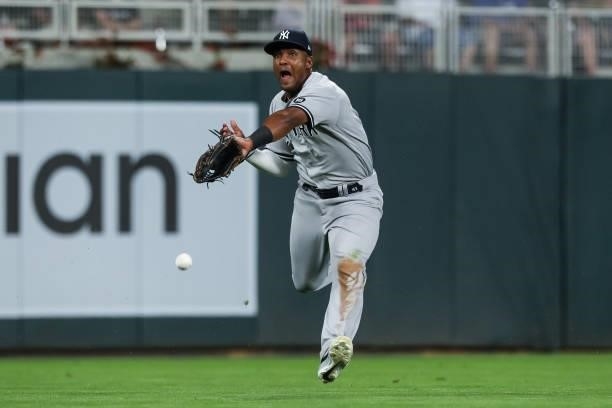 Miguel Andujar of the New York Yankees reaches for but can't catch a ball hit by Trevor Larnach of the Minnesota Twins for a single in the fifth...