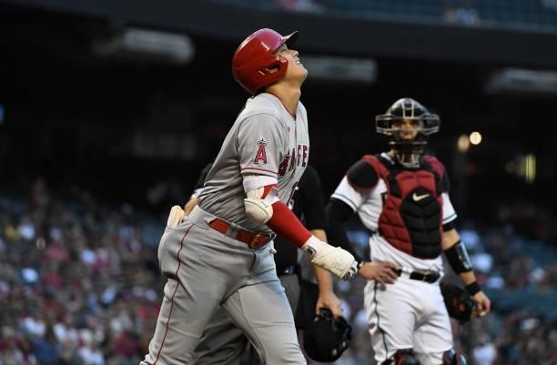 Shohei Ohtani of the Los Angeles Angels reacts after hitting a foul ball off of his knee during the third inning against the Arizona Diamondbacks at...