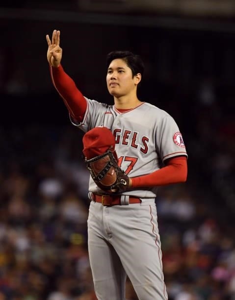 Shohei Ohtani of the Los Angeles Angels signals to catcher Kurt Suzuki during a game against the Arizona Diamondbacks at Chase Field on June 11, 2021...