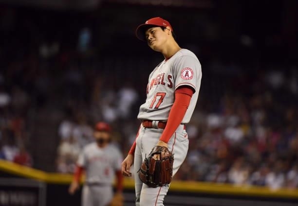 Shohei Ohtani of the Los Angeles Angels reacts after giving up a run on a balk during the fifth inning against the Arizona Diamondbacks at Chase...