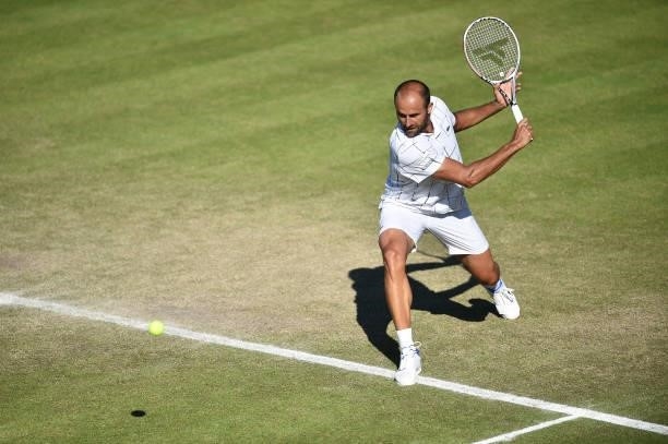 Marius Copil of Romania plays a backhand against Frances Tiafore of United States during the men's semi-finals match on day eight of the Viking Open...