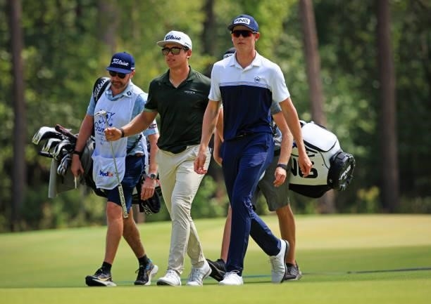 Garrick Higgo of South Africa and Wilco Nienaber of South Africa walk from the 11th green during the third round of the Palmetto Championship at...