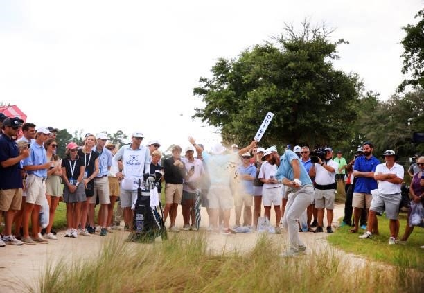 Dustin Johnson plays his third shot out of the sand on the 12th hole during the third round of the Palmetto Championship at Congaree on June 12, 2021...