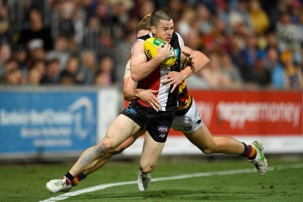 Jack Higgins of the Saints is tackled during the round 13 AFL match between the St Kilda Saints and the Adelaide Crows at Cazaly's Stadium on June...