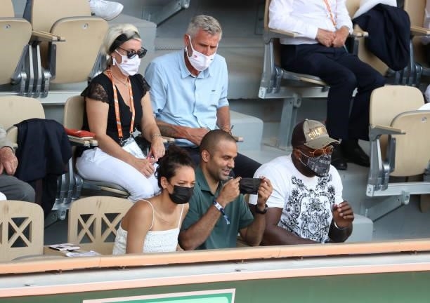 Tony Parker, his girlfriend Alize Lim , Teddy Riner, above them President of French Tennis Federation FFT Gilles Moretton attend day 13 of the 2021...