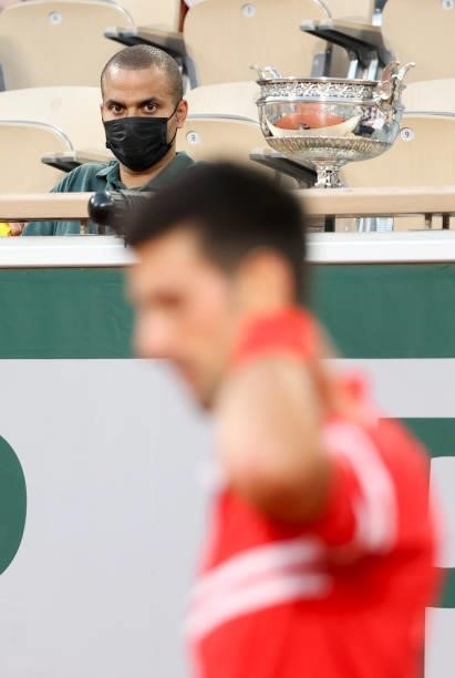 Tony Parker watching Novak Djokovic of Serbia during day 13 of the 2021 Roland-Garros, French Open, a Grand Slam tennis tournament at Roland-Garros...