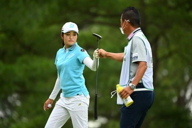 Mone Inami of Japan fist bumps with her caddie on the 8th green during the final round of the Ai Miyazato Suntory Ladies Open at Rokko Kokusai Golf...