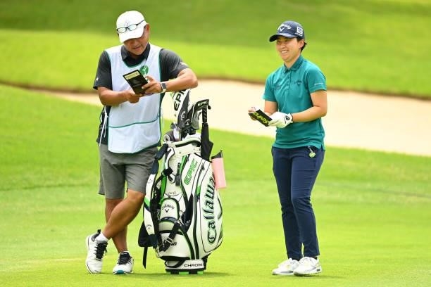Seira Oki of Japan shares a laugh with her caddie on the 18th fairway during the final round of the Ai Miyazato Suntory Ladies Open at Rokko Kokusai...