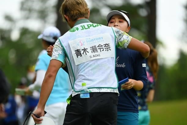 Serena Aoki of Japan hugs with her caddie after winning the tournament on the 18th green during the final round of the Ai Miyazato Suntory Ladies...