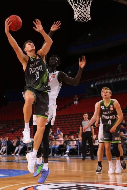 Yanni Wetzall of the Phoenix drives to the basket under pressure from Jo Lual-Acuil of United during game two of the NBL Semi-Final Series between...
