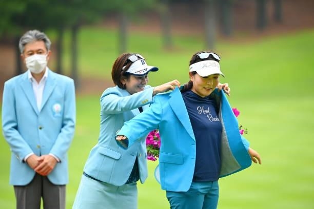 Serena Aoki of Japan is put the winner's jacket by tournament ambassador Ai Miyazato at the award ceremony following the final round of the Ai...