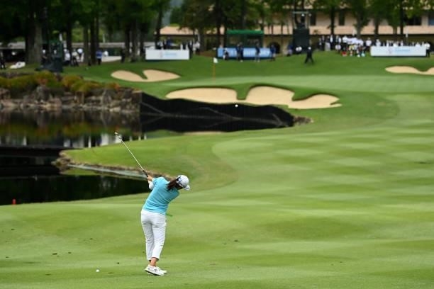 Mone Inami of Japan hits her second shot on the 18th hole during the final round of the Ai Miyazato Suntory Ladies Open at Rokko Kokusai Golf Club on...