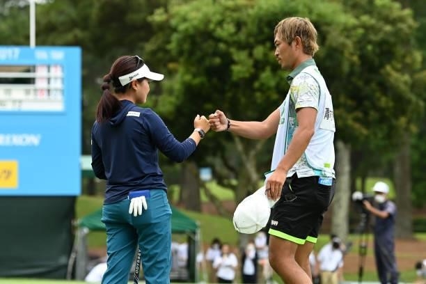 Serena Aoki of Japan fist bumps with her caddie Shota Onishi after the winning putt on the 18th green during the final round of the Ai Miyazato...