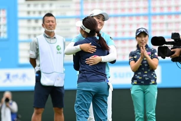 Serena Aoki of Japan is congratulated by Mone Inami of Japan after winning the tournament on the 18th green during the final round of the Ai Miyazato...