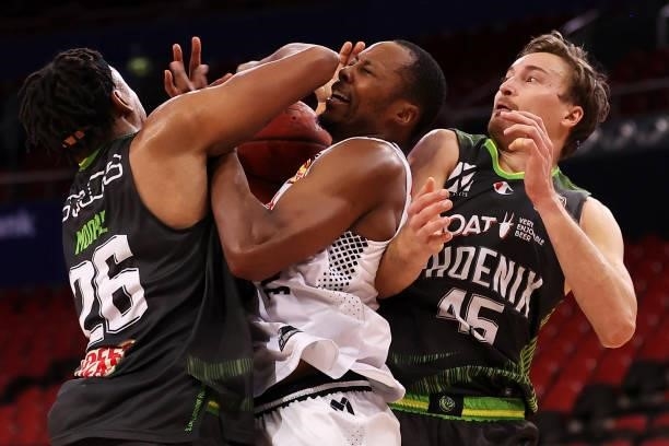 Ben Moore and Ryan Broekhoff of the Phoenix compete for the ball with Scotty Hopson of Melbourne United during game two of the NBL Semi-Final Series...