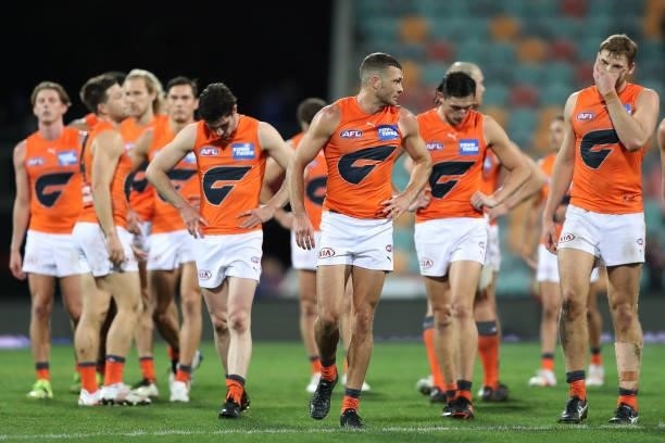 The Giants look dejected after the game ended in a draw during the round 13 AFL match between the North Melbourne Kangaroos and the Greater Western...
