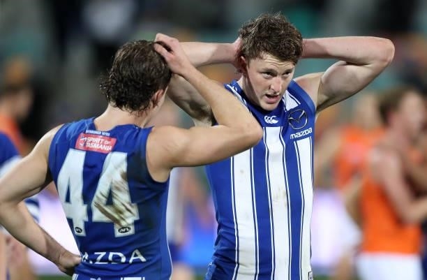 Cameron Zurhaar and Nick Larkey of the Kangaroos look dejected after the game ended in a draw during the round 13 AFL match between the North...