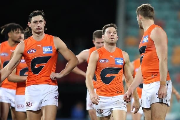 Toby Greene and his Giants team mates look dejected after the game ended in a draw during the round 13 AFL match between the North Melbourne...