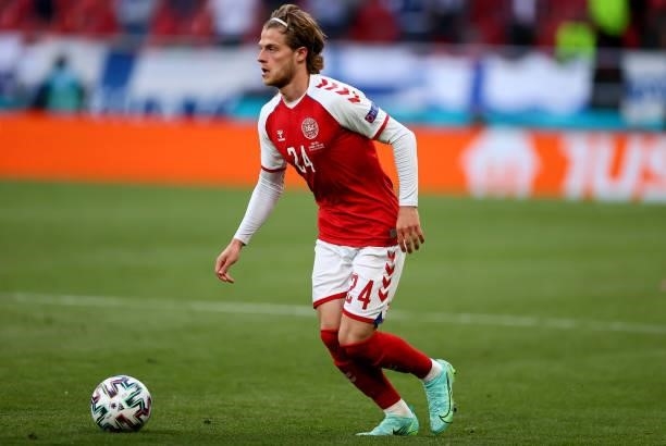 Mathias Jensen of Denmark runs with the ball during the UEFA Euro 2020 Championship Group B match between Denmark and Finland on June 12, 2021 in...