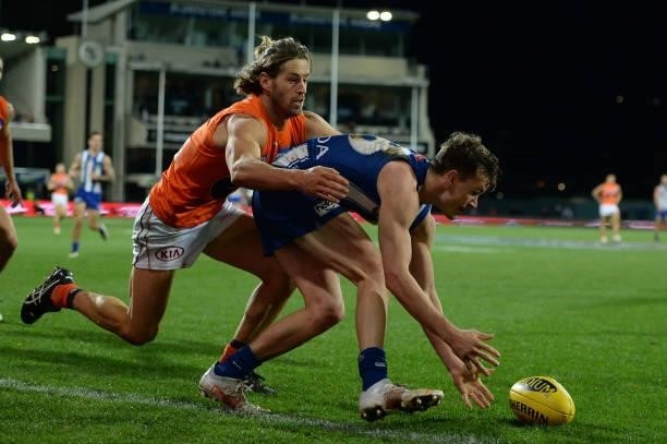 Callan Ward of the Giants tackles Kayne Turner of the Kangaroos during the round 13 AFL match between the North Melbourne Kangaroos and the Greater...