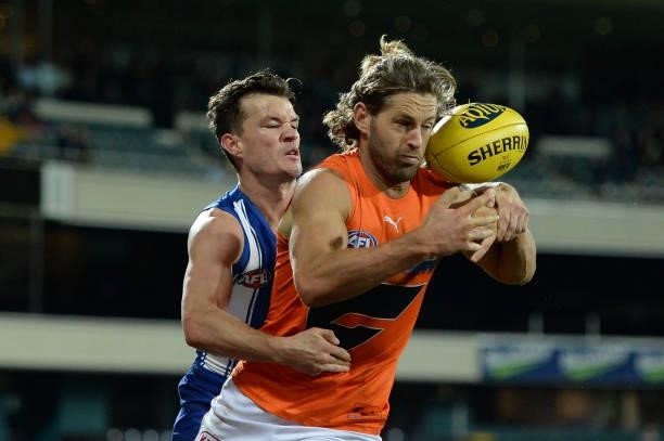 Kayne Turner of the Kangaroos tackles Callan Ward of the Giants during the round 13 AFL match between the North Melbourne Kangaroos and the Greater...