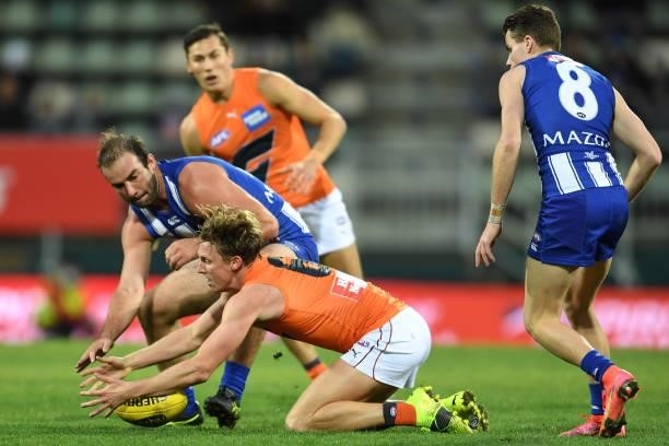 Ben Cunnington of the Kangaroos and Lachie Whitfield of the Giants competes for the ball during the round 13 AFL match between the North Melbourne...