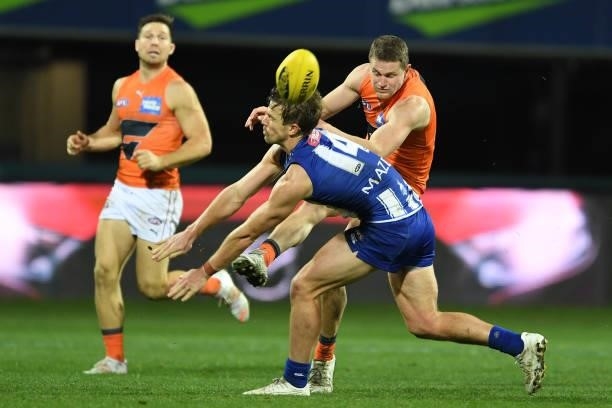 Trent Dumont of the Kangaroos tries to block a kick during the round 13 AFL match between the North Melbourne Kangaroos and the Greater Western...