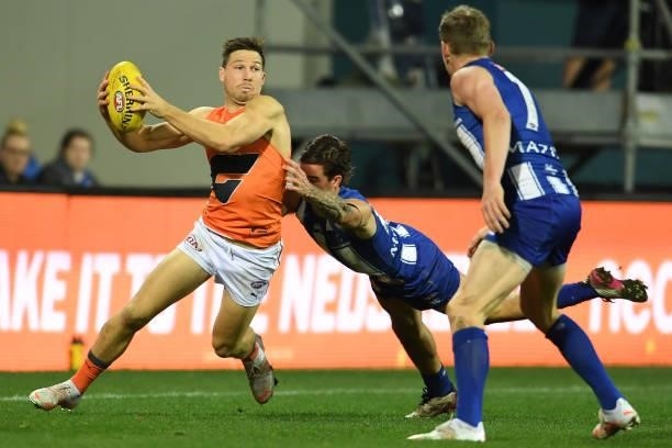 Toby Greene of the Giants breaks a tackle during the round 13 AFL match between the North Melbourne Kangaroos and the Greater Western Sydney Giants...