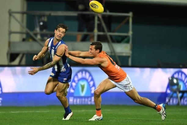 Jy Simpkin of the Kangaroos handballs during the round 13 AFL match between the North Melbourne Kangaroos and the Greater Western Sydney Giants at...