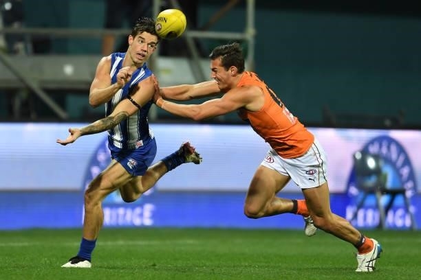 Jy Simpkin of the Kangaroos handballs during the round 13 AFL match between the North Melbourne Kangaroos and the Greater Western Sydney Giants at...