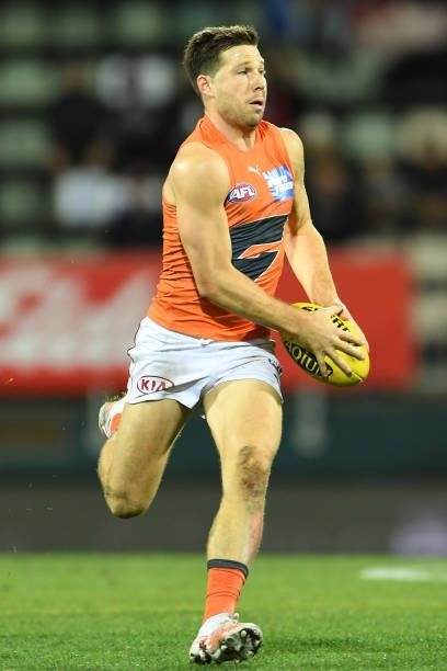 Toby Greene of the Giants runs the ball during the round 13 AFL match between the North Melbourne Kangaroos and the Greater Western Sydney Giants at...
