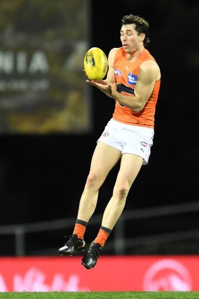 Isaac Cumming of the Giants takes a mark during the round 13 AFL match between the North Melbourne Kangaroos and the Greater Western Sydney Giants at...