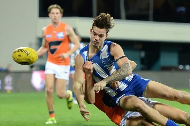 Jy Simpkin of the Kangaroos is tackled during the round 13 AFL match between the North Melbourne Kangaroos and the Greater Western Sydney Giants at...