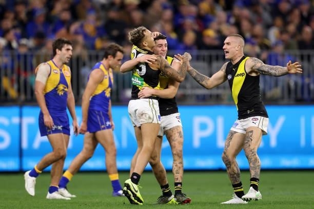Shai Bolton, Jason Castagna and Dustin Martin of the Tigers celebrate a goal during the round 14 AFL match between the West Coast Eagles and the...