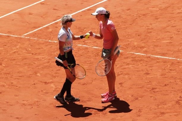 Bethanie Mattek-Sands of The United States and playing partner Iga Swiatek of Poland discuss tactics in their Women's Doubles Final match against...