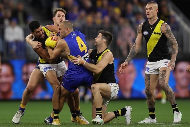 Dom Sheed of the Eagles gets tackled by Marlion Pickett and Trent Cotchin of the Tigers during the round 14 AFL match between the West Coast Eagles...