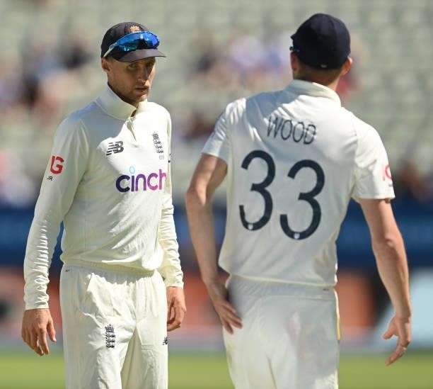 Joe Root of England talks to Mark Wood during the second LV= Test match against New Zealand at Edgbaston on June 13, 2021 in Birmingham, England.