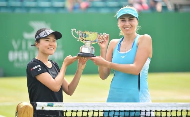 Makoto Ninomya of Japan and Lyudmyla Kichenok of Ukraine hold the Viking Open Trophy after they win the women’s doubles final between Caroline...